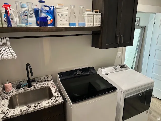 Laundry area featuring washer and dryer and wood finished floors