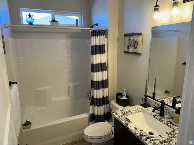 Full bath with shower / bath combo with shower curtain and vanity