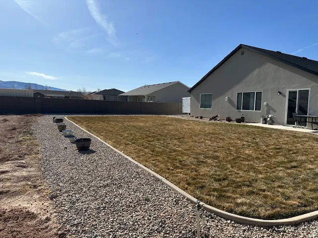 Fenced backyard with a patio area