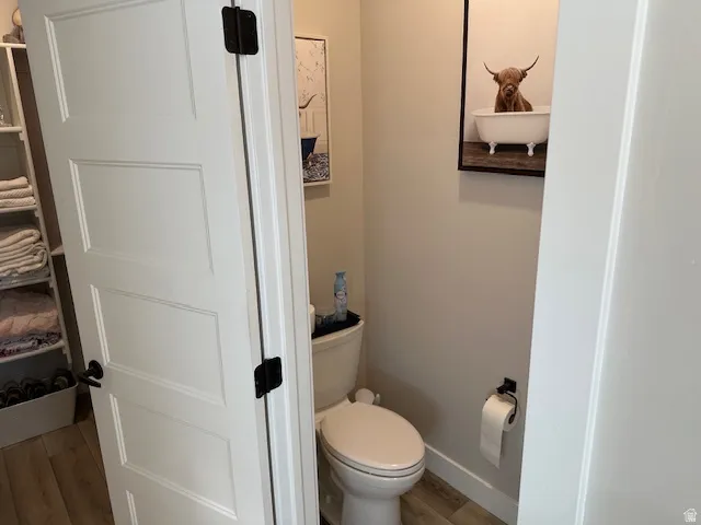 Bathroom featuring light wood-style floors and toilet