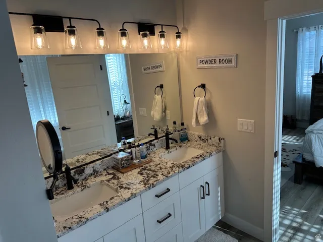 Ensuite bathroom with double vanity and baseboards