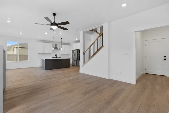 Unfurnished living room with ceiling fan, light wood-type flooring, and recessed lighting