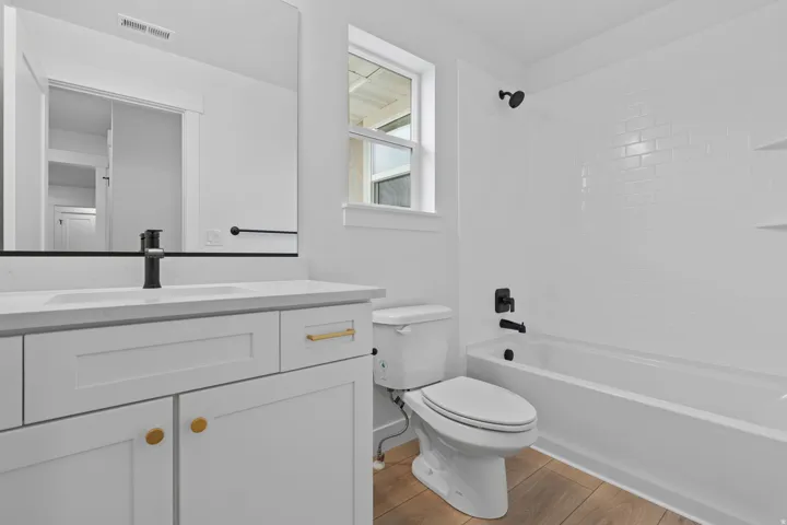 Full bath with vanity, bathing tub / shower combination, and light wood finished floors