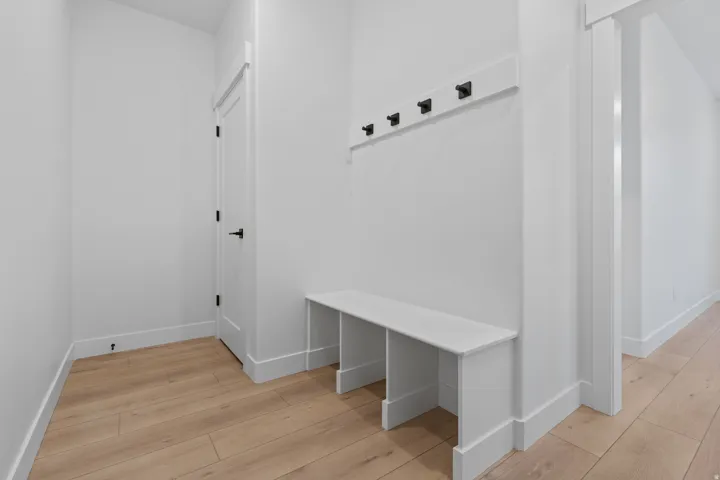 Mudroom with baseboards and light wood-type flooring