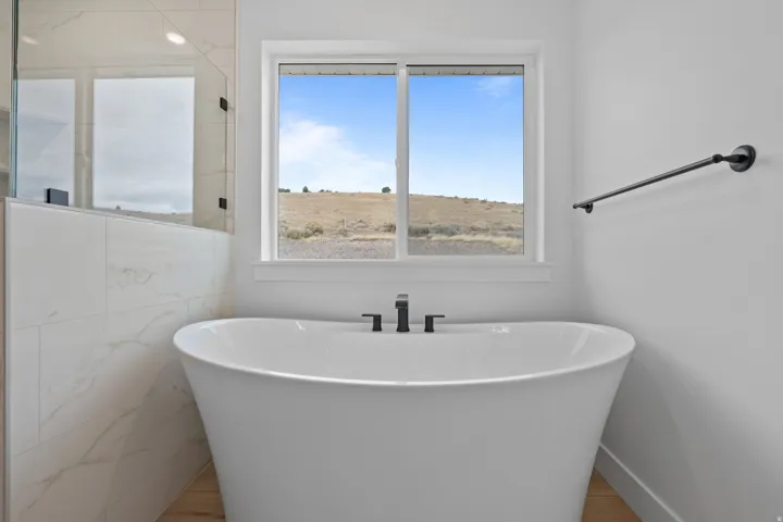 Bathroom featuring a freestanding tub and wood finished floors