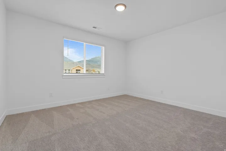 Carpeted empty room with baseboards