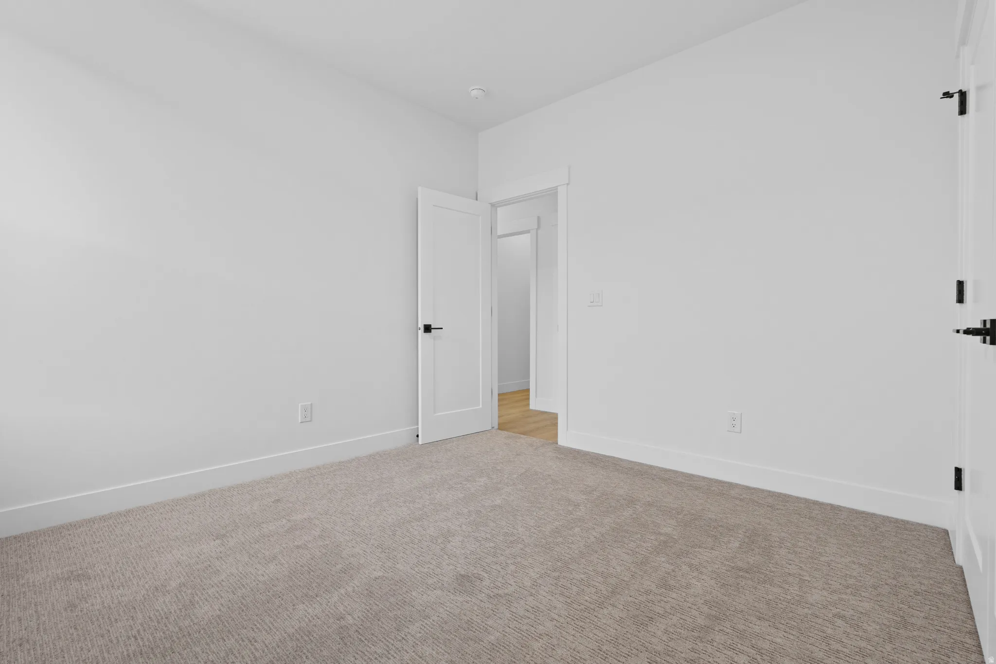 Unfurnished room featuring baseboards and carpet flooring