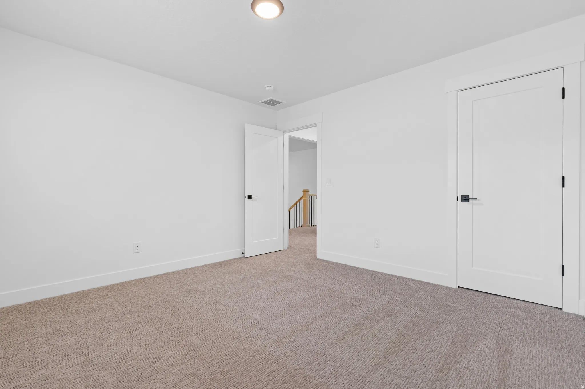 Unfurnished bedroom featuring baseboards and carpet flooring