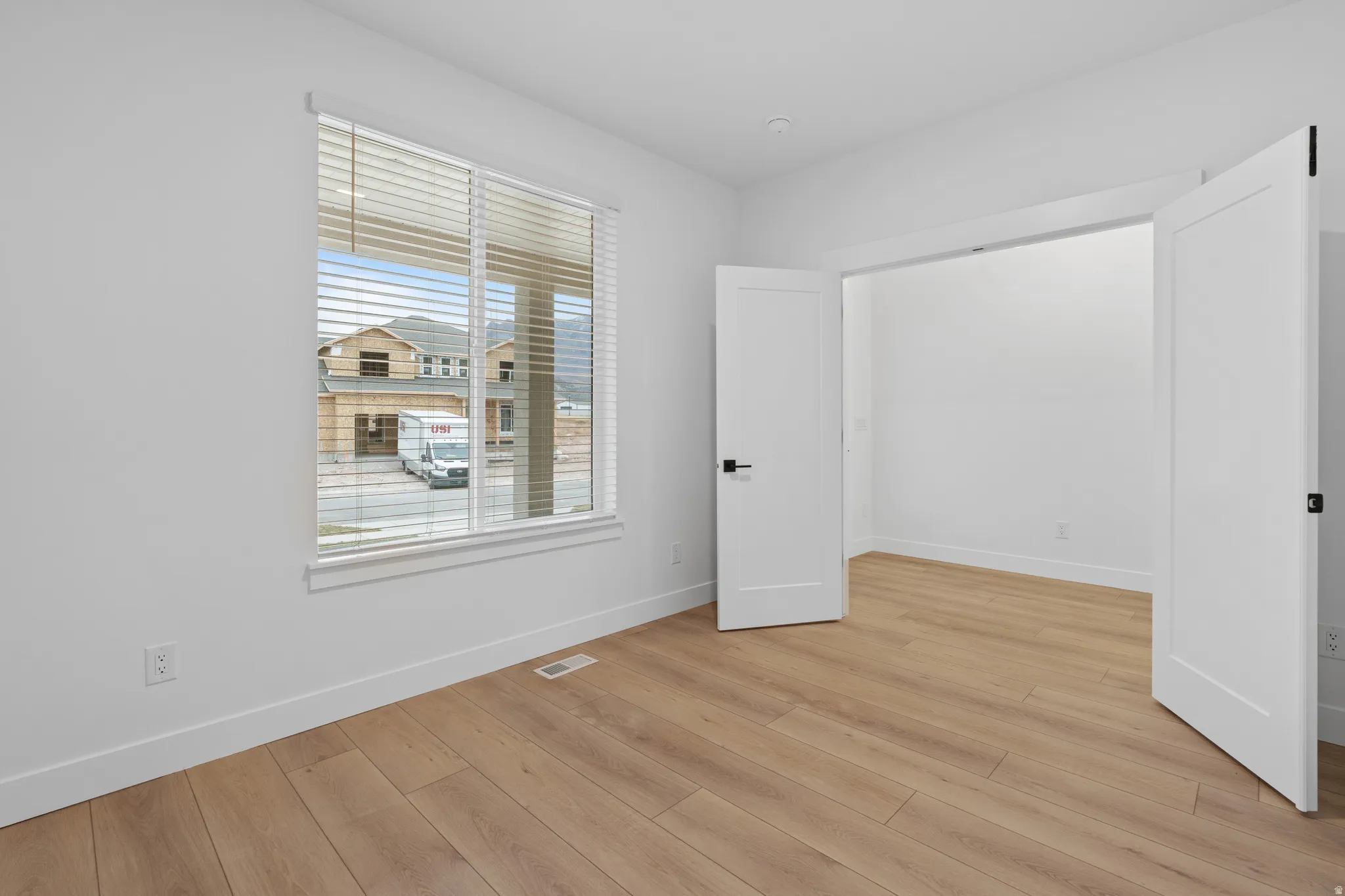 Unfurnished bedroom with light wood finished floors