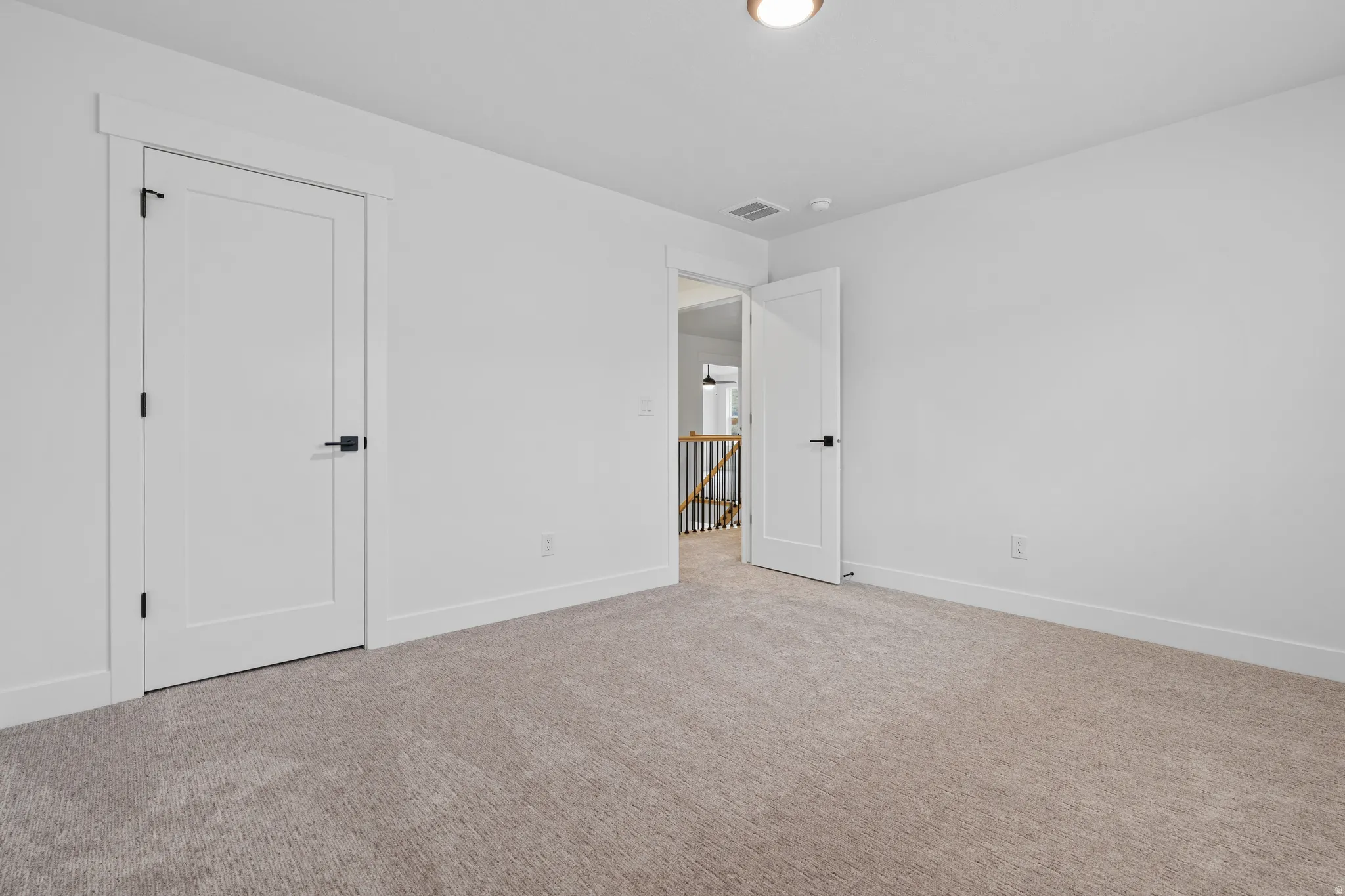 Unfurnished bedroom with carpet flooring and baseboards