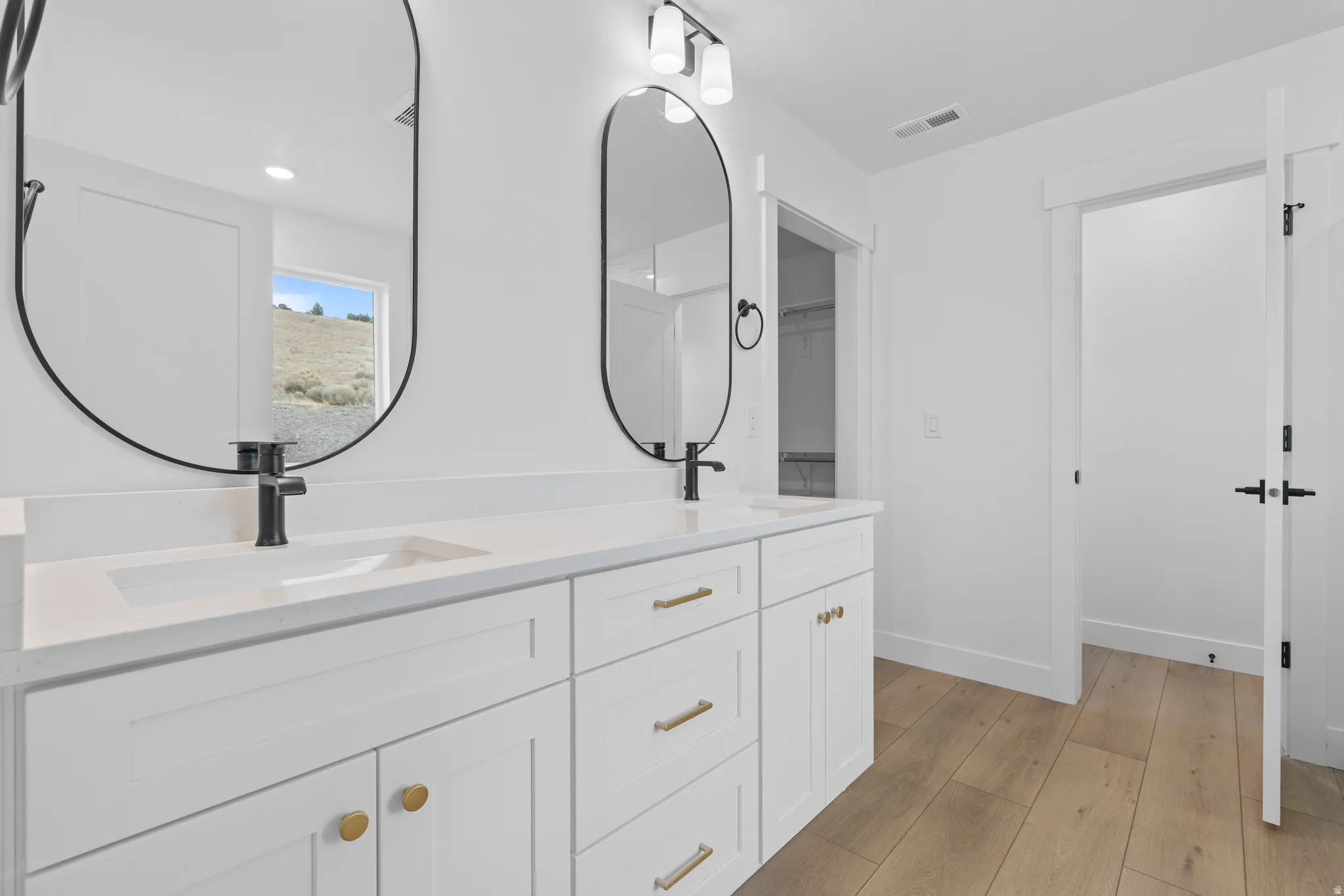 Full bathroom featuring light wood-type flooring, double vanity, and recessed lighting