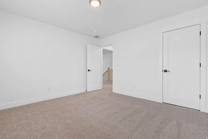 Unfurnished bedroom featuring baseboards and carpet flooring