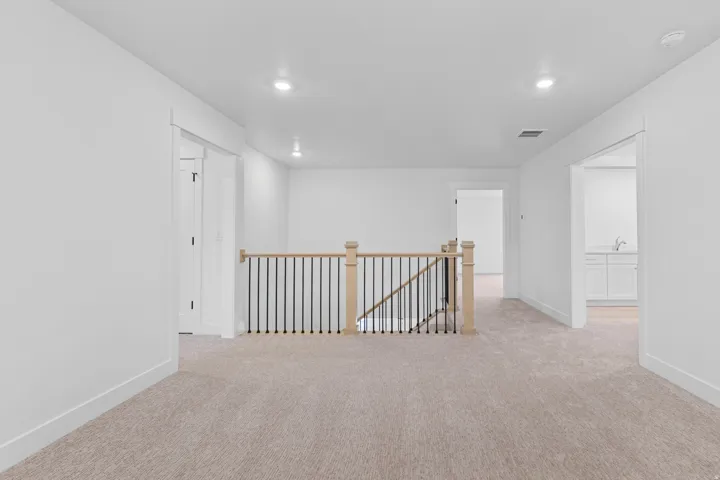 Spare room with light colored carpet and recessed lighting