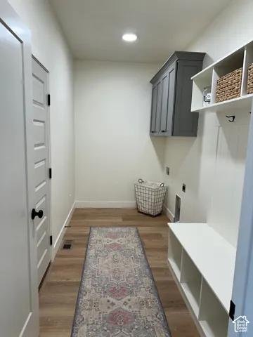 Mudroom with light wood-style floors and recessed lighting