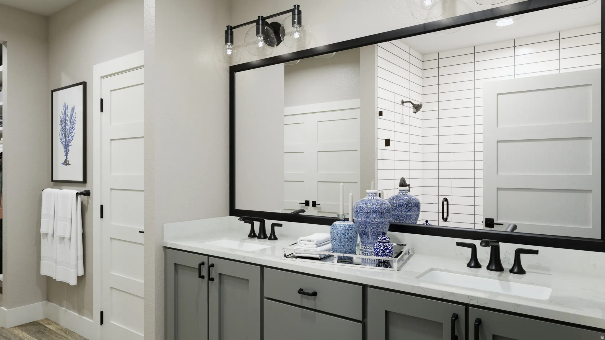 Bathroom featuring a shower stall and double vanity