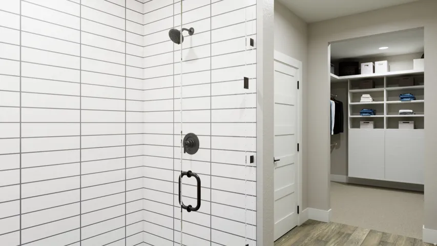 Bathroom featuring a stall shower, wood finished floors, and a walk in closet