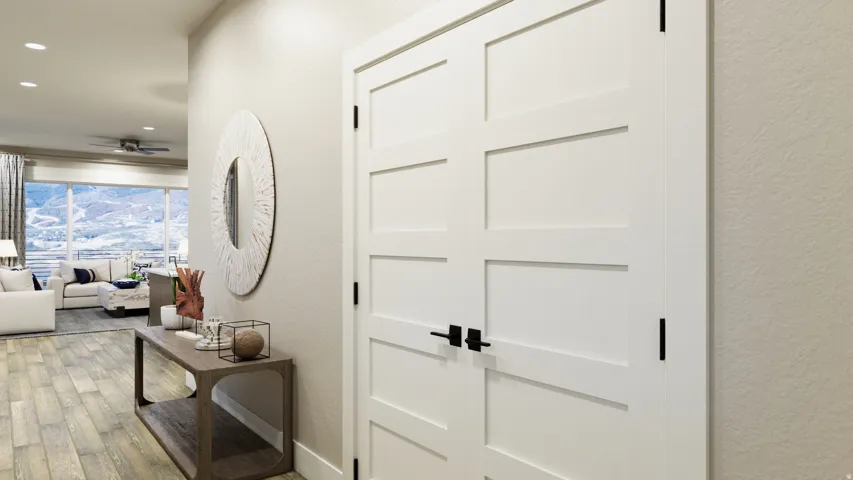 Corridor featuring light wood finished floors, a textured wall, and recessed lighting