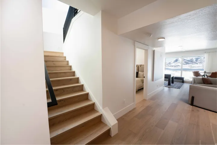 Staircase featuring wood finished floors and a textured ceiling