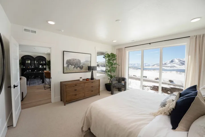 Carpeted bedroom featuring a mountain view and access to exterior