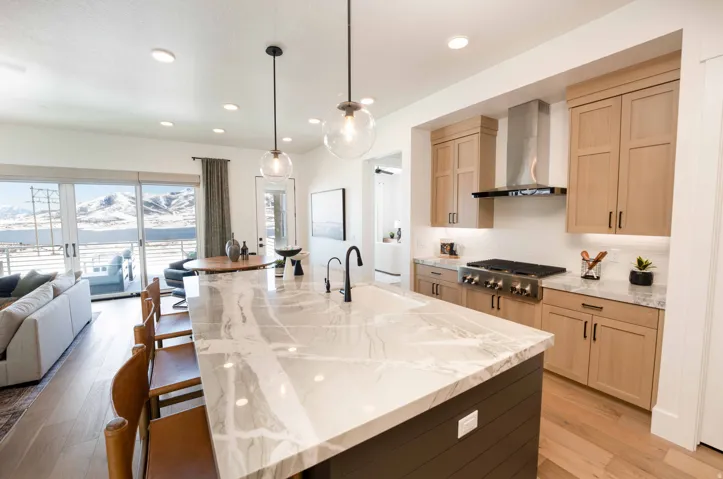 Kitchen featuring light stone countertops, light wood finish cabinetry, light wood-style floors, and a mountain view