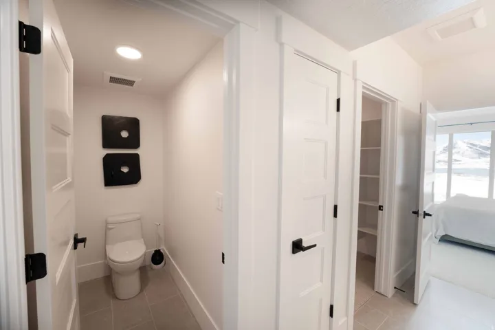 Ensuite bathroom featuring toilet and light tile patterned floors