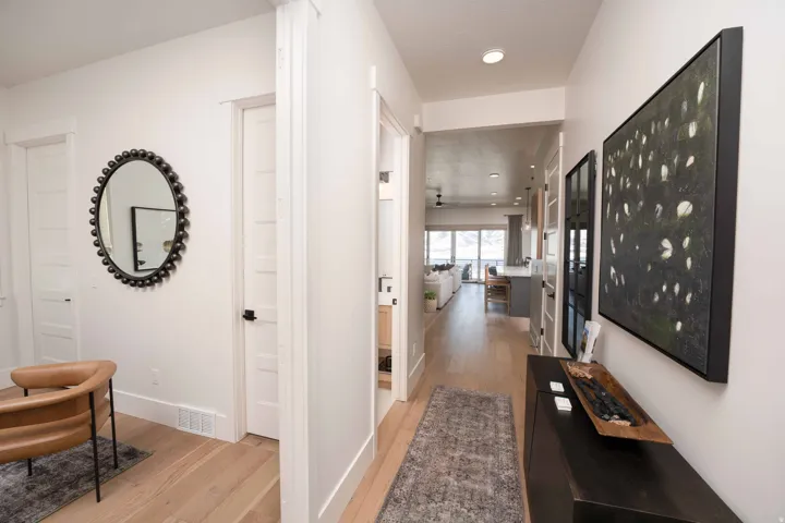 Hall with light wood-style floors and recessed lighting