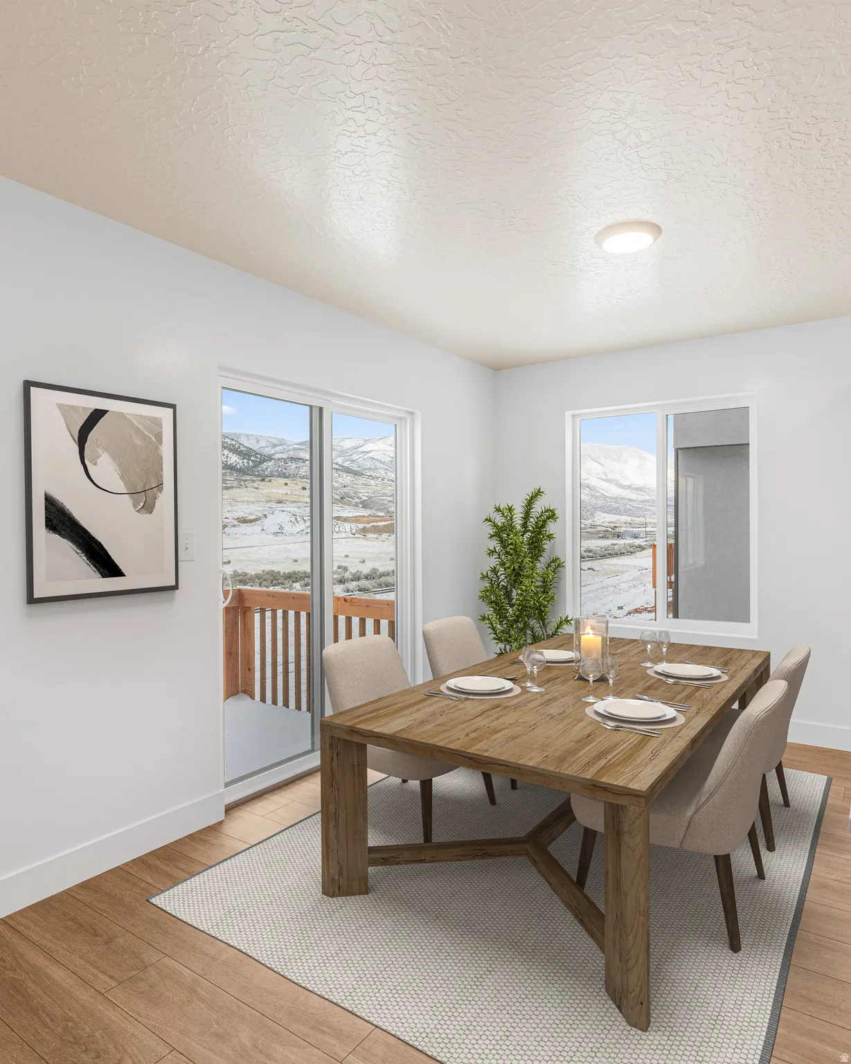 Dining room featuring a textured ceiling, light wood-style flooring, and a mountain view