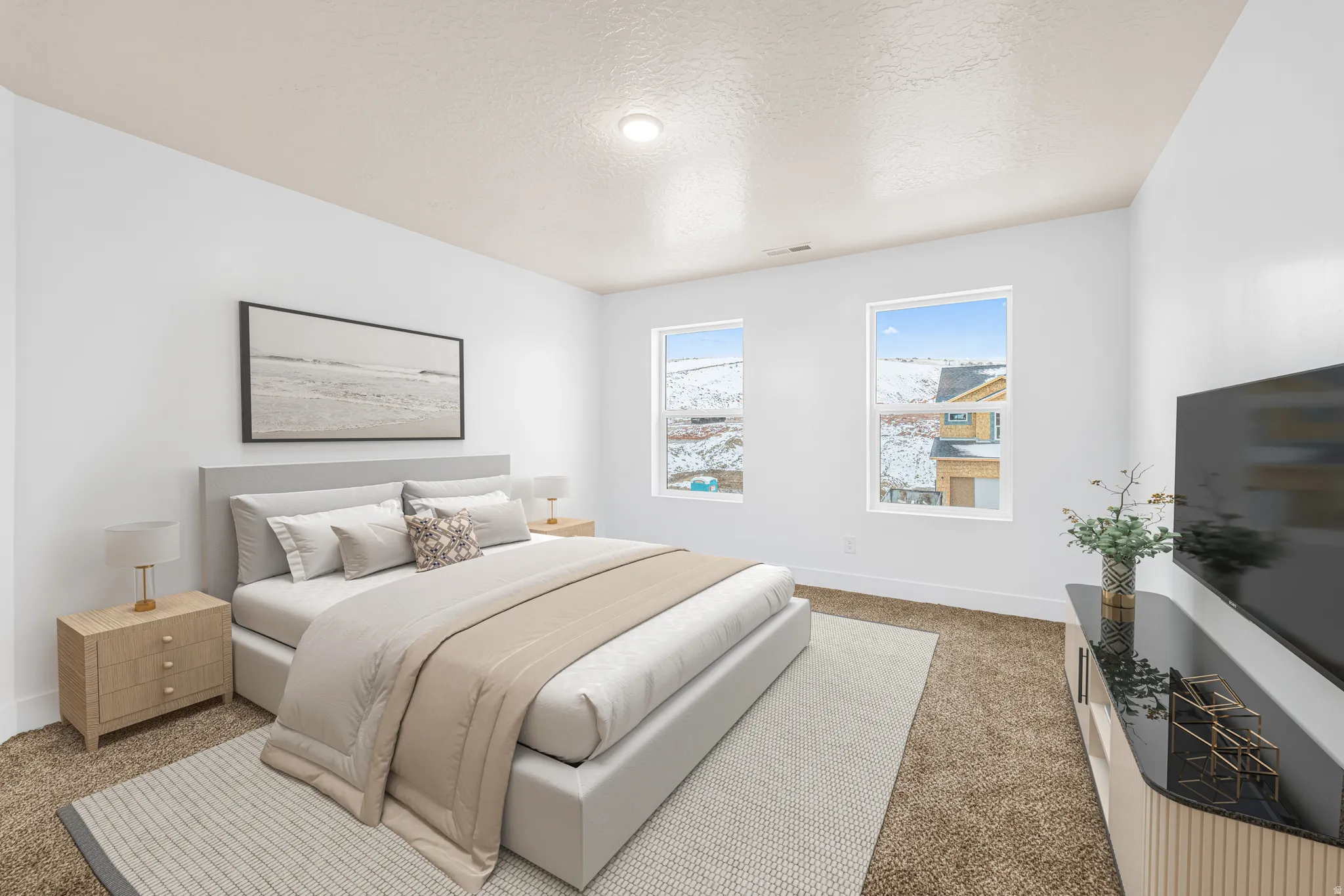 Bedroom featuring light colored carpet and a textured ceiling