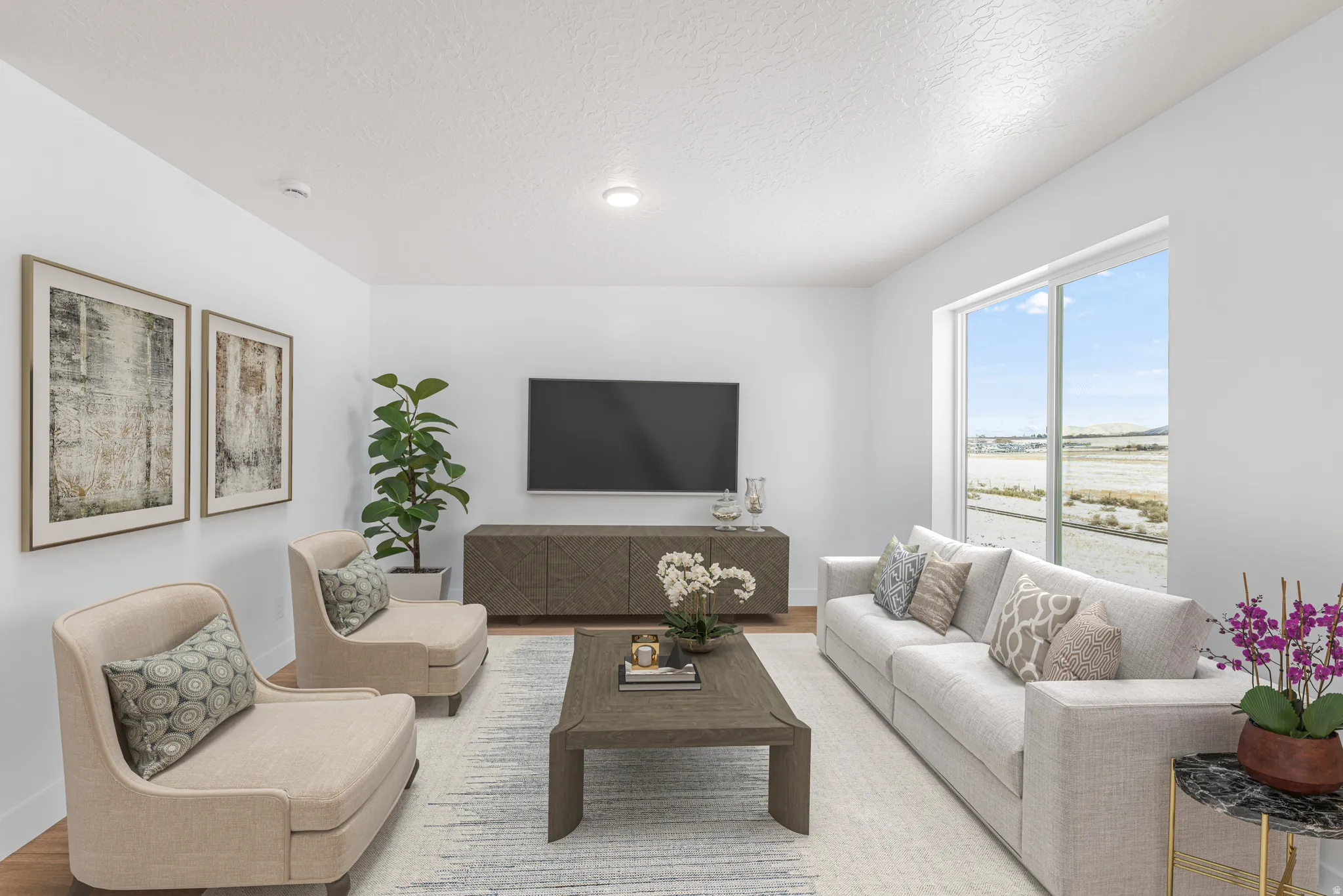 Living room with a textured ceiling and wood finished floors