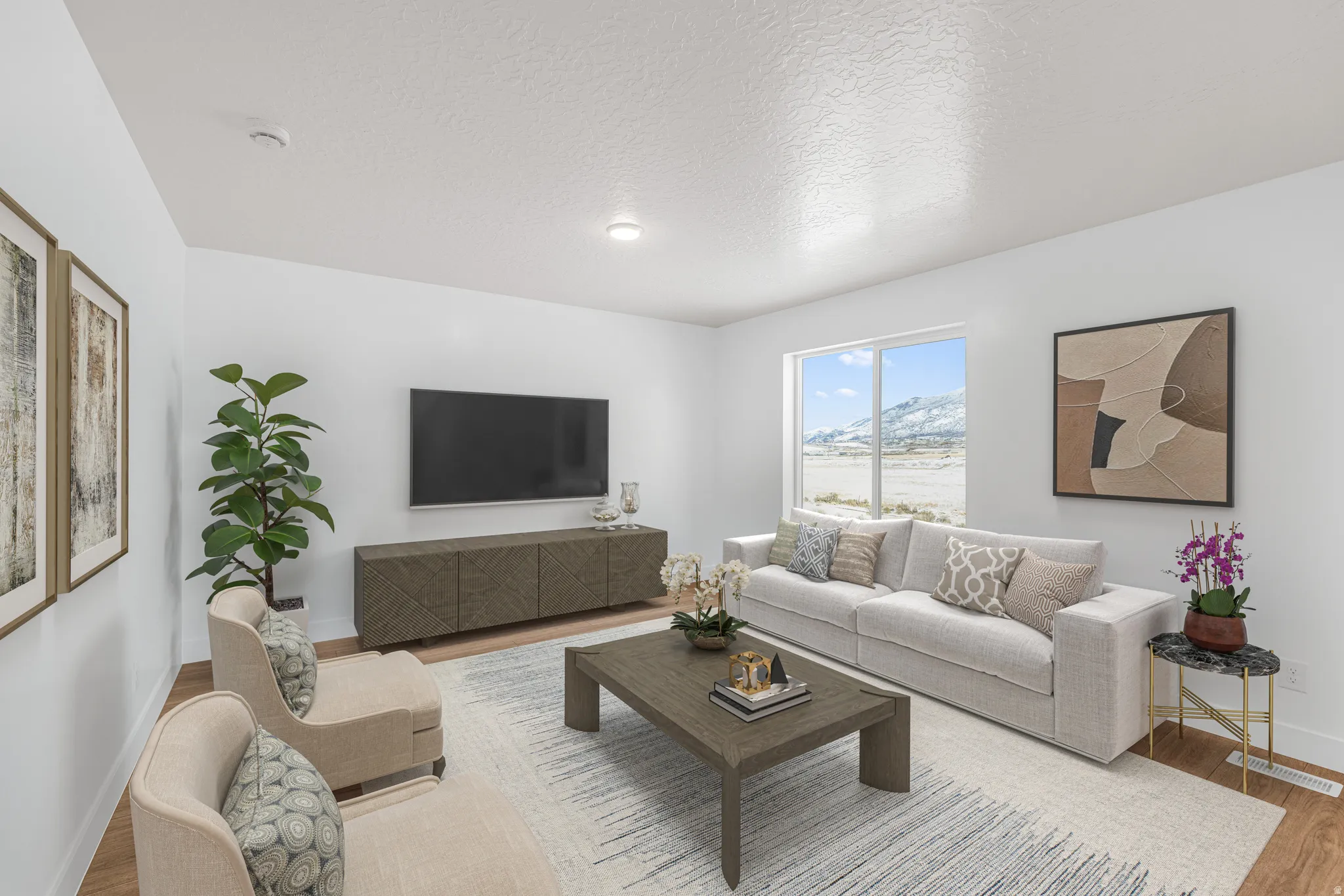 Living area with wood finished floors and a textured ceiling