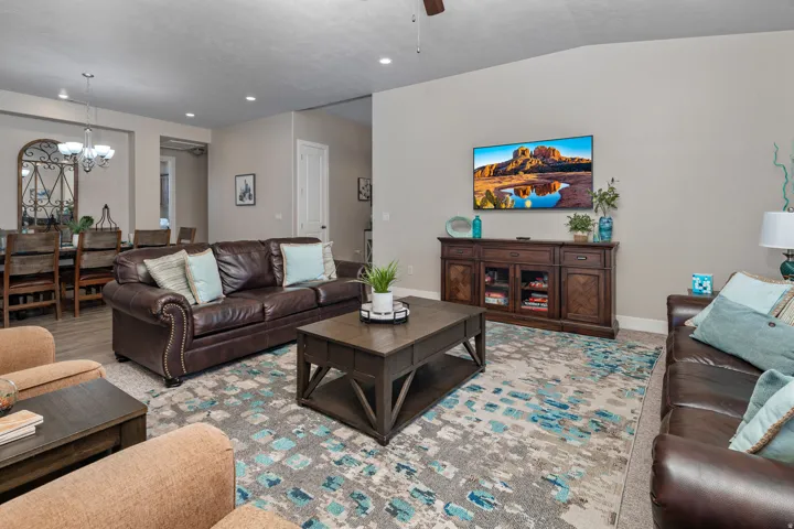 Living room with a chandelier and a ceiling fan