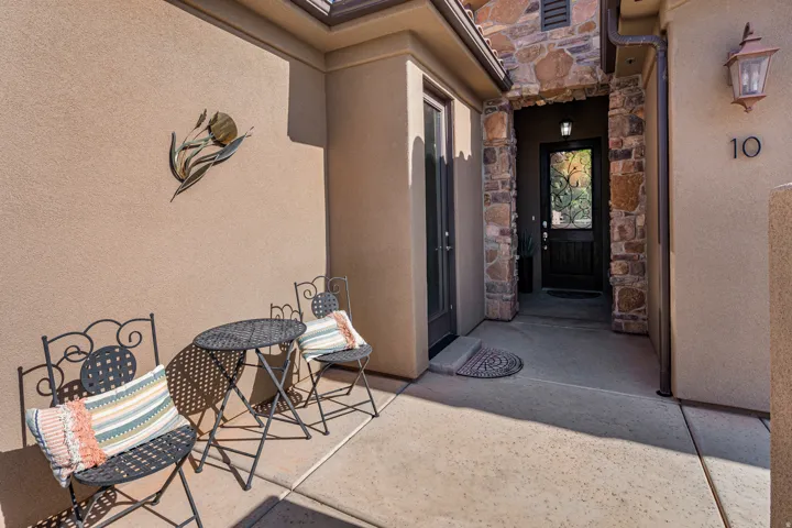 View of exterior entry with stone siding and stucco siding