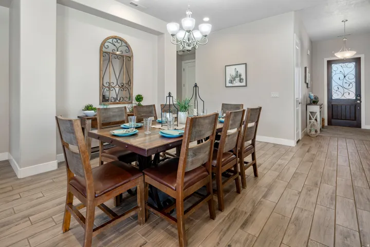 Dining space featuring wood finish floors and a chandelier