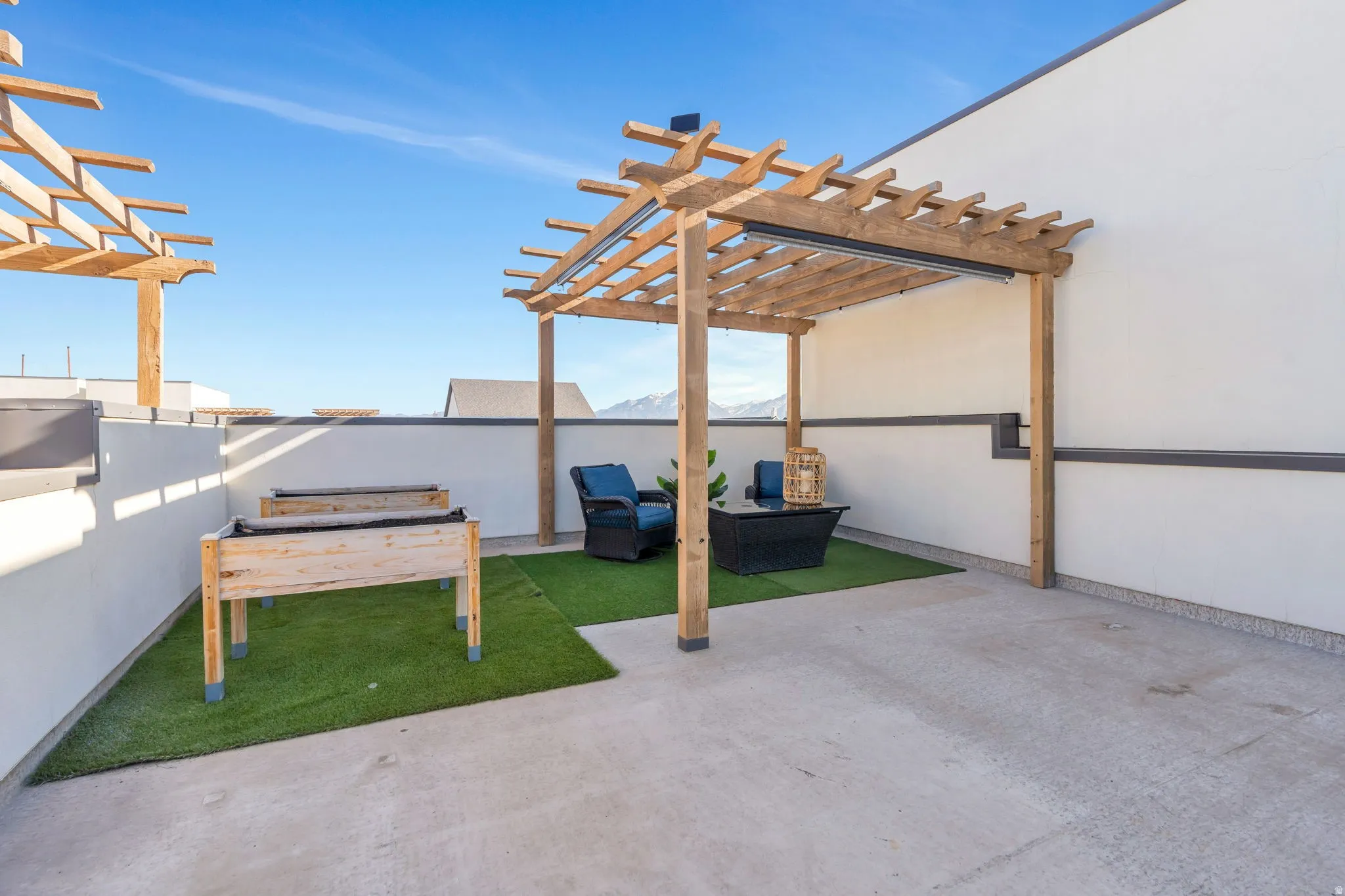 Terrace space featuring turf mats, planting boxes, and built in pergola