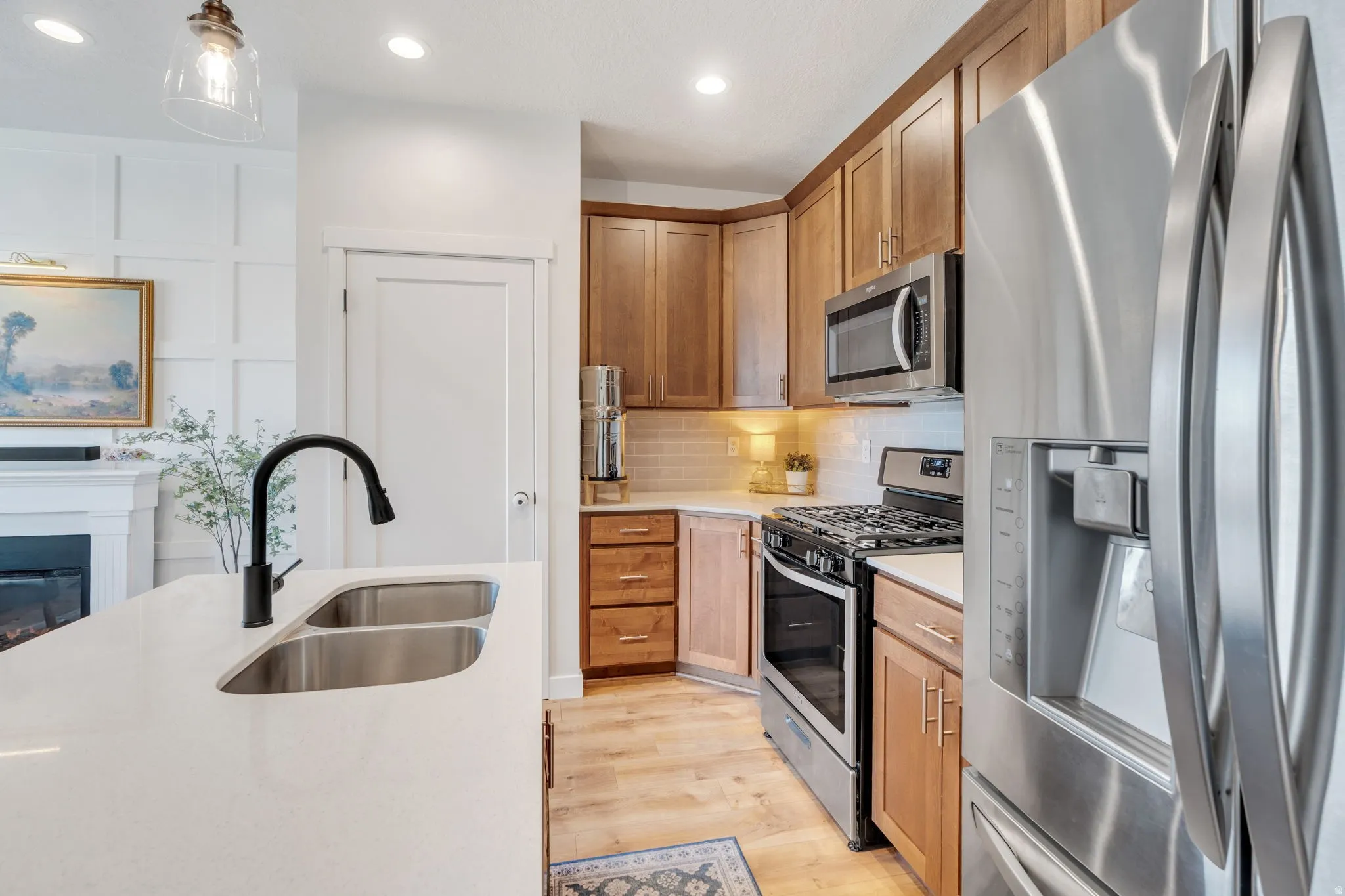 Rich cabinetry & stainless steel appliances give this kitchen a warm feel. v