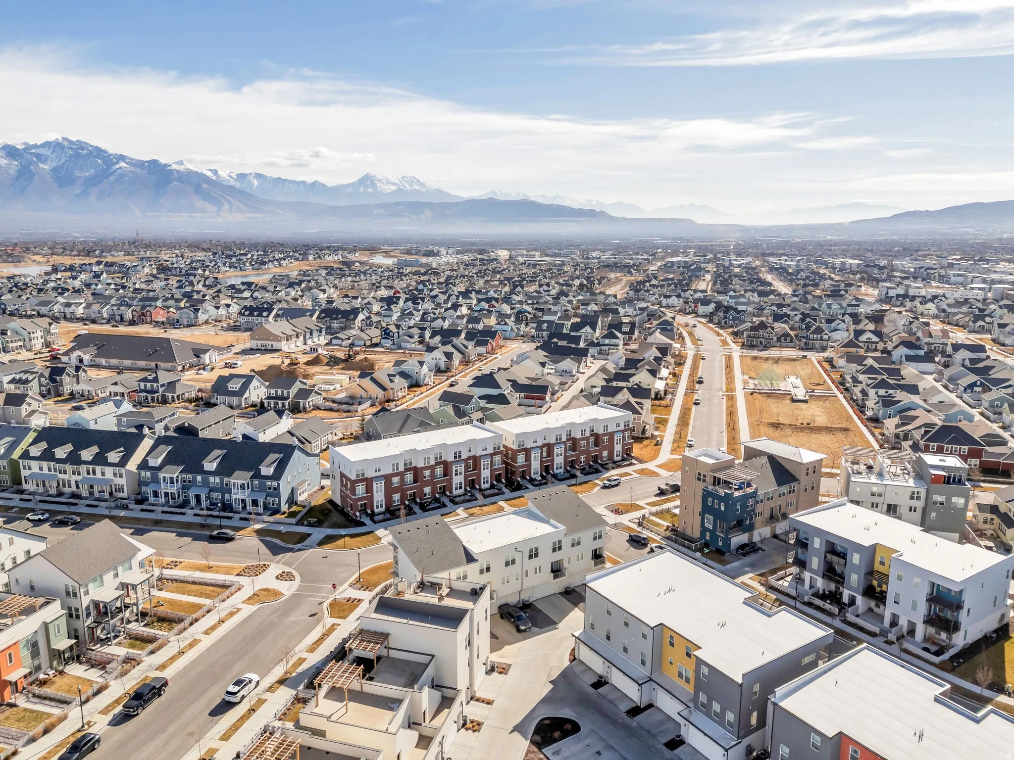 Aerial perspective of suburban area with a mountainous background