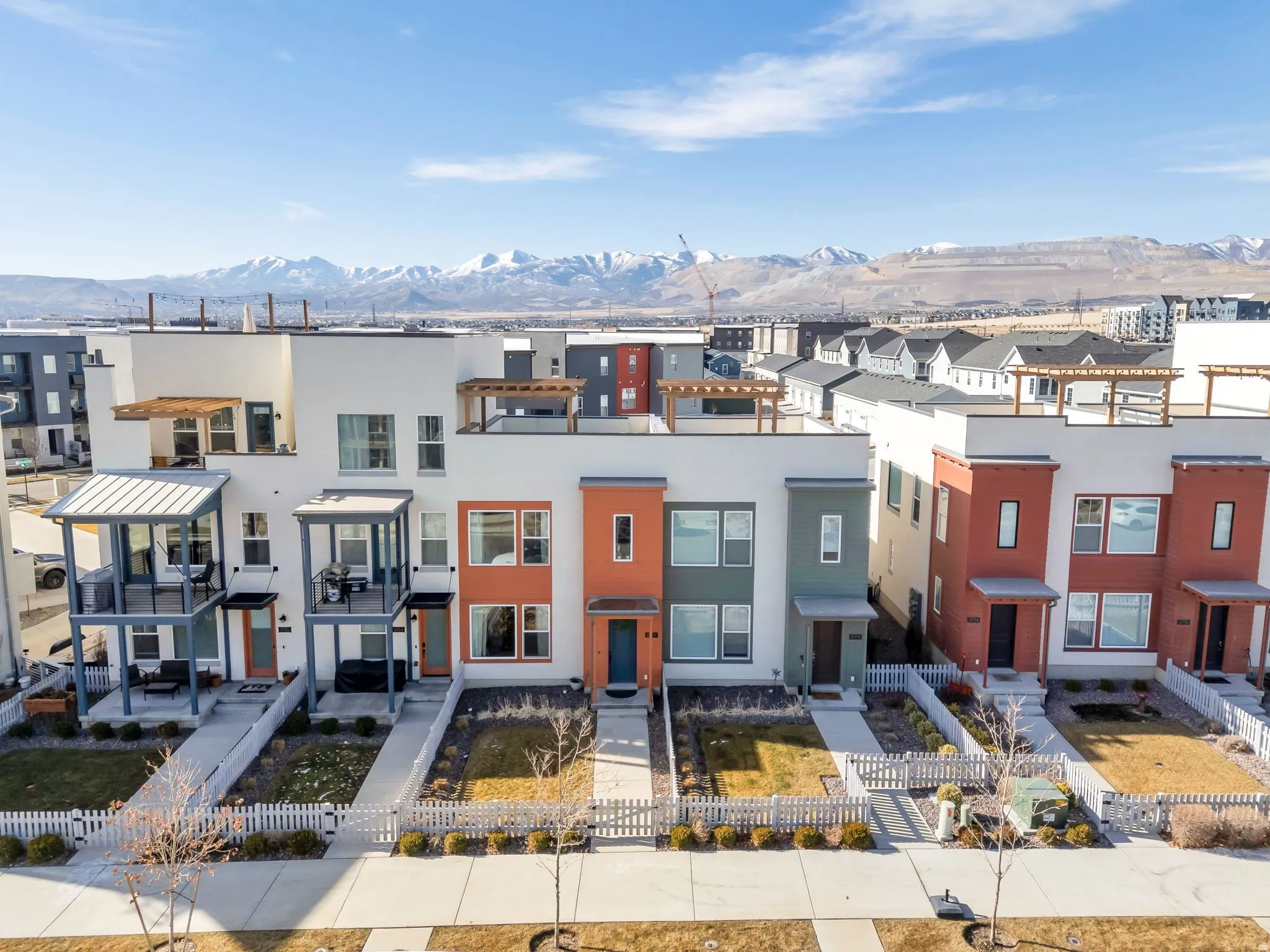 View of front of property featuring stucco siding, a mountain view, and a fenced front yard