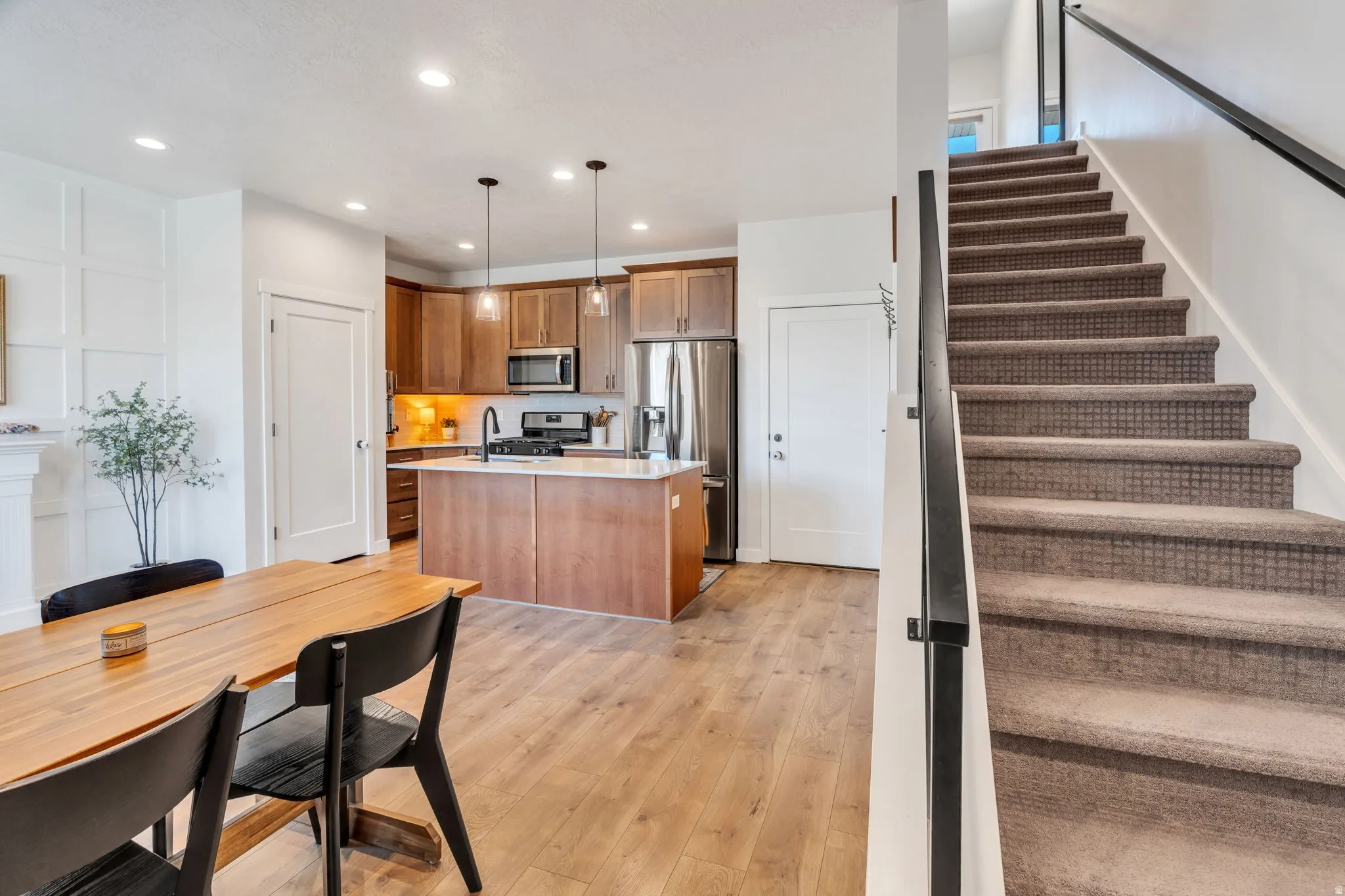 Featuring the kitchen and dining space with a staircase to the upper levels