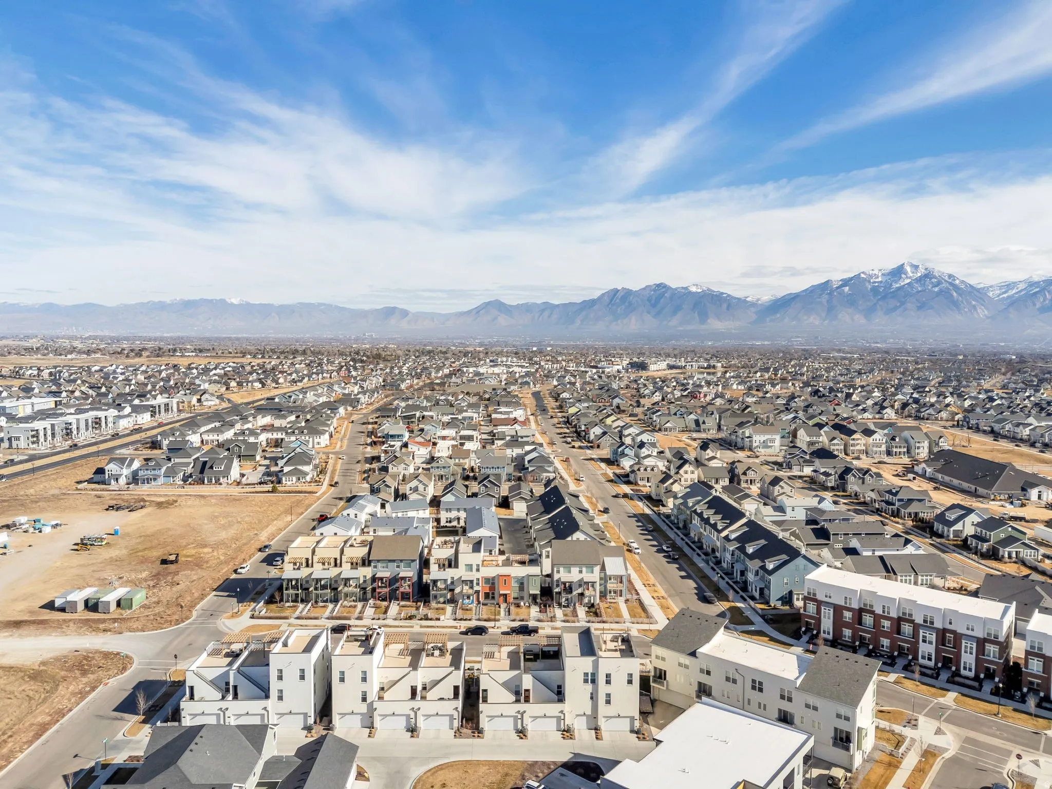 Aerial view of residential area featuring a mountainous background