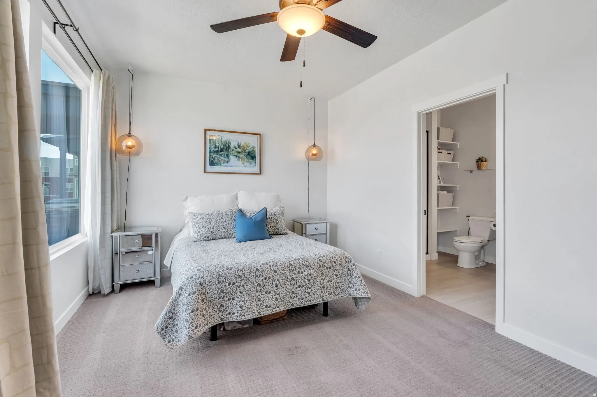 Beautiful primary suite featuring plush carpet, ample natural light, and attached ensuite