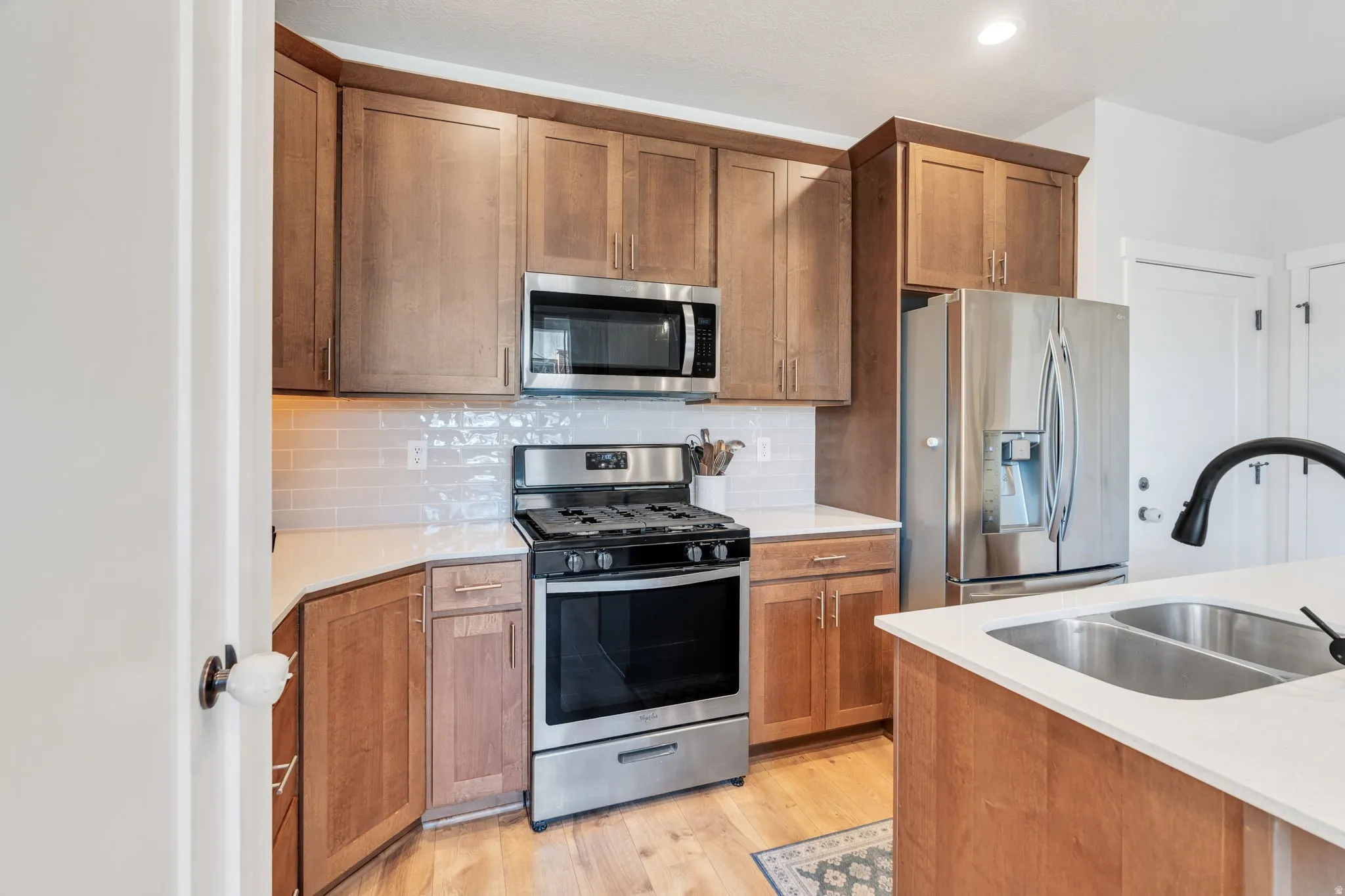 Rich cabinetry featuring stainless steel appliances, and kitchen island