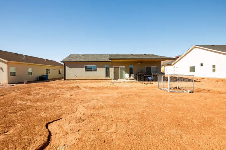 Back of house featuring a patio, stucco siding, and ceiling fan