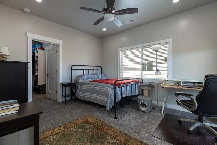 Bedroom featuring a spacious closet, an office area, carpet flooring, ceiling fan, and recessed lighting