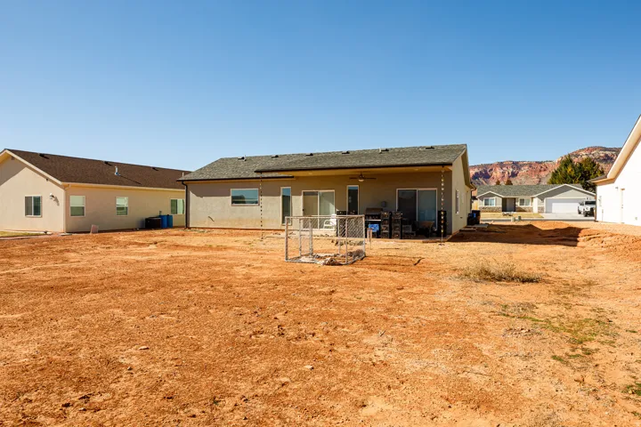 Rear view of property featuring a patio area, stucco siding, a mountain view, and ceiling fan