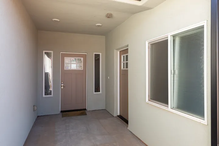 Doorway to property featuring stucco siding