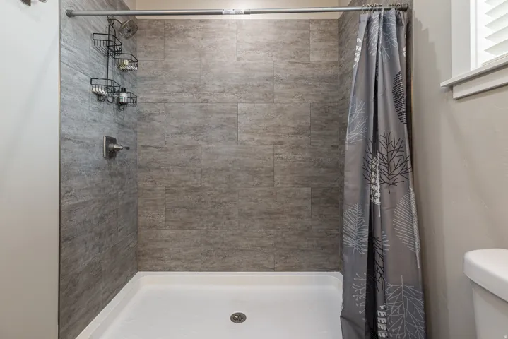 Full bathroom with a stall shower and toilet