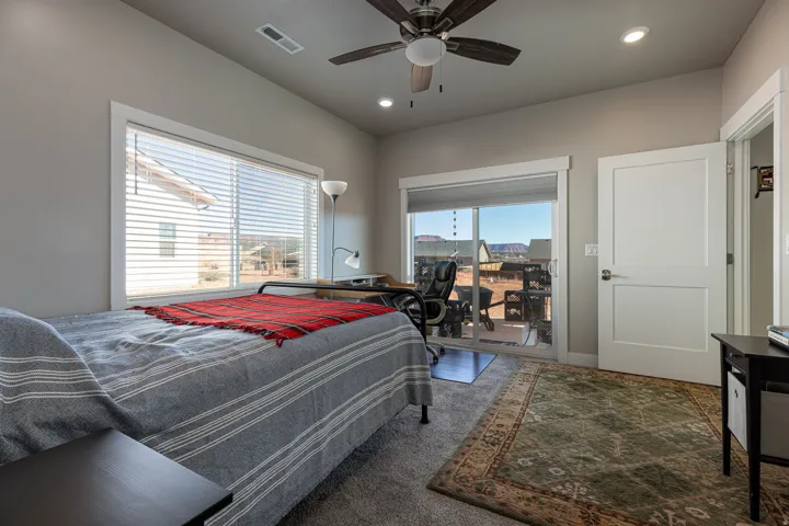 Bedroom featuring access to outside, ceiling fan, dark colored carpet, and recessed lighting