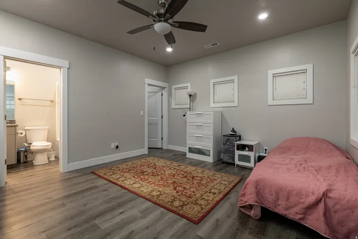 Bedroom featuring dark wood-type flooring, a ceiling fan, and recessed lighting