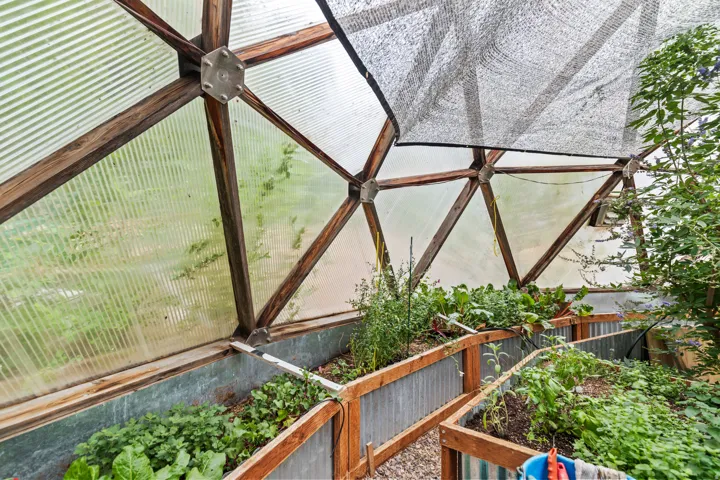 Detailed view of an exterior structure and a vegetable garden