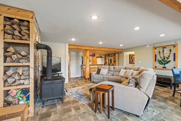 Living room featuring recessed lighting and a wood stove